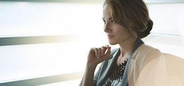 Filtered-portrait-of-an-executive-business-woman-writing-on-a-glass-wall-at-sunset-1