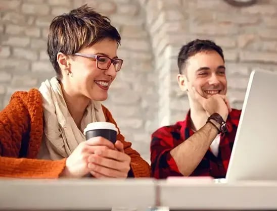 Two businesspeople smile at REC recruitment data