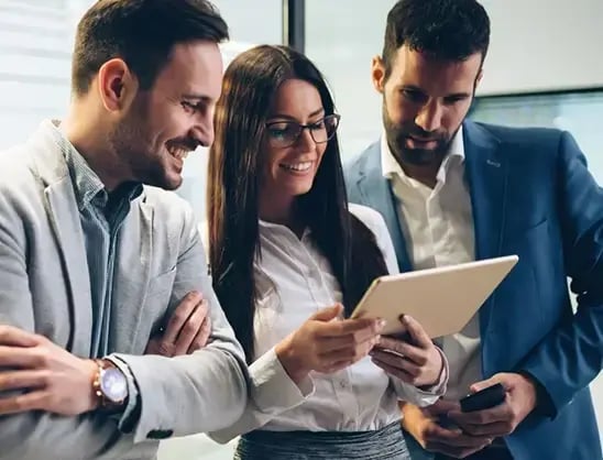 Colleagues use a tablet to examine how Saltbox combines Sage Intacct, Bullhorn, and RSM InTime into one seamless workflow