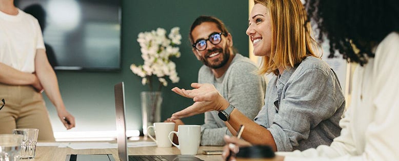 Young businesspeople work happily together in an office