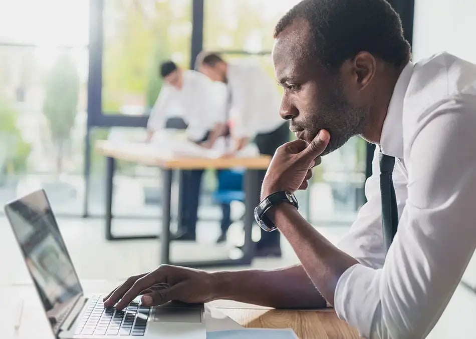 Man working on a laptop in an office setting