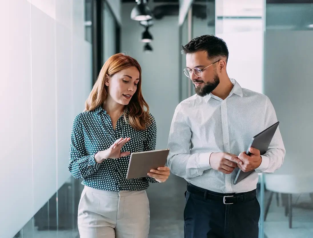 Coworkers using SAP Business One looking at a tablet with copilot