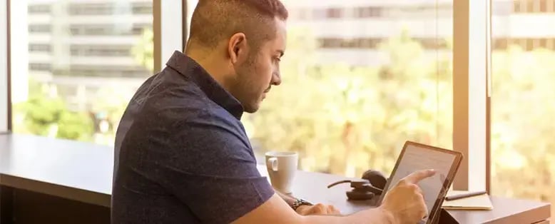 Worker looking at SAP Business One Tips and Tricks on his computer screen