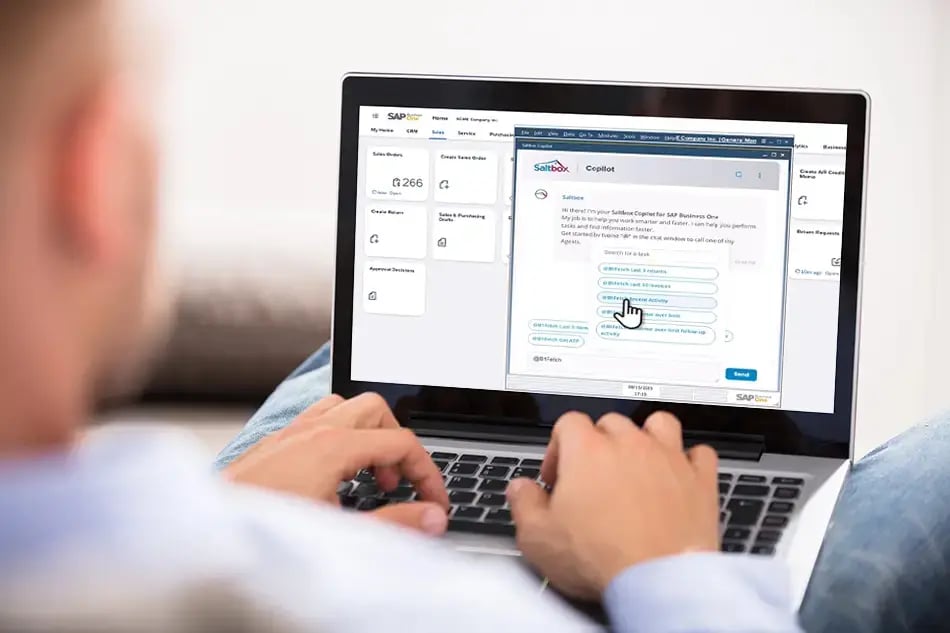 Man on laptop showing a screenshot of Copilot for SAP Business One B1Query