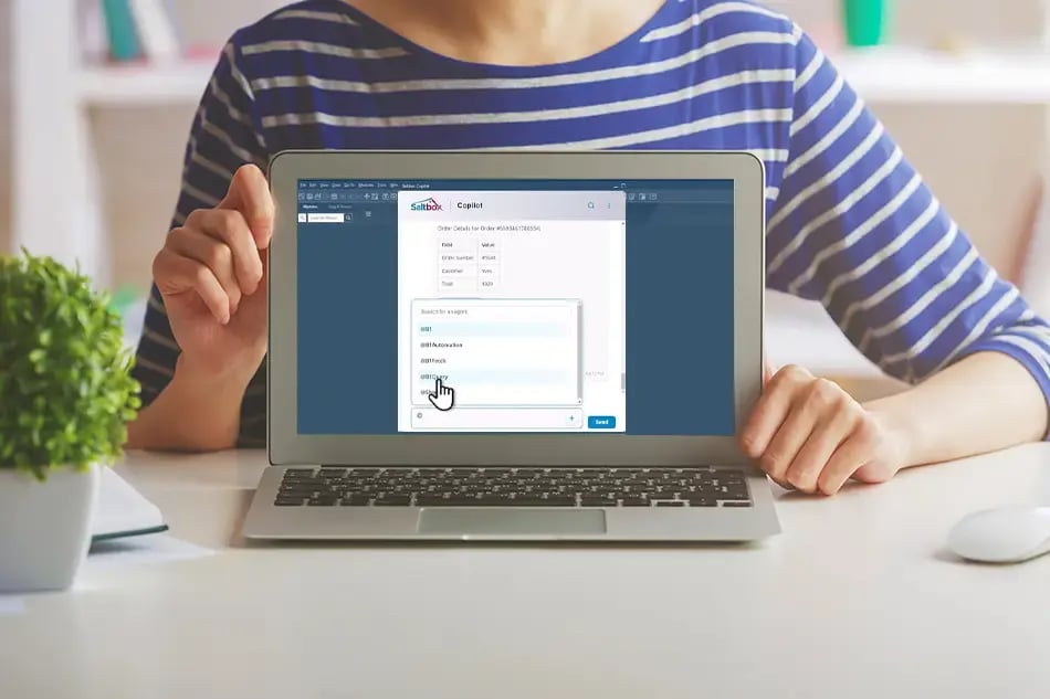 Woman on laptop showing a screenshot of Copilot for SAP Business One B1 Fetch Recent Activity Task