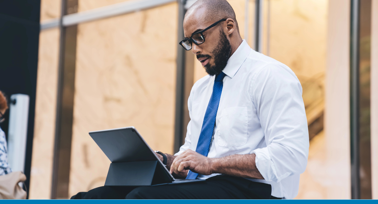 Businessman in glasses works with SAP Business One Web Client on a laptop