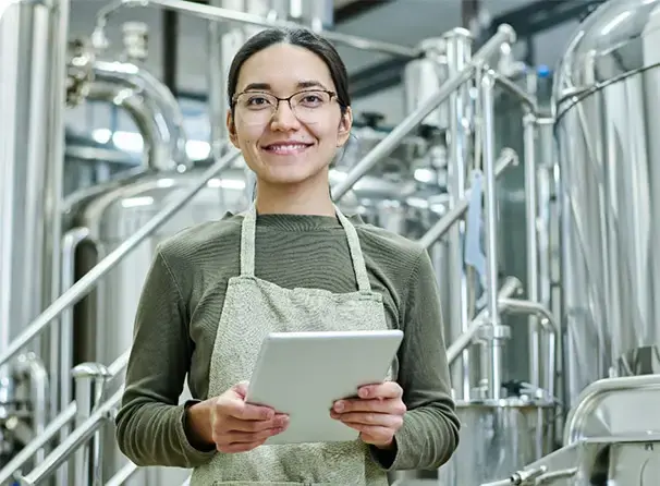 Lady with her tablet with brewery software to help manage her brewery