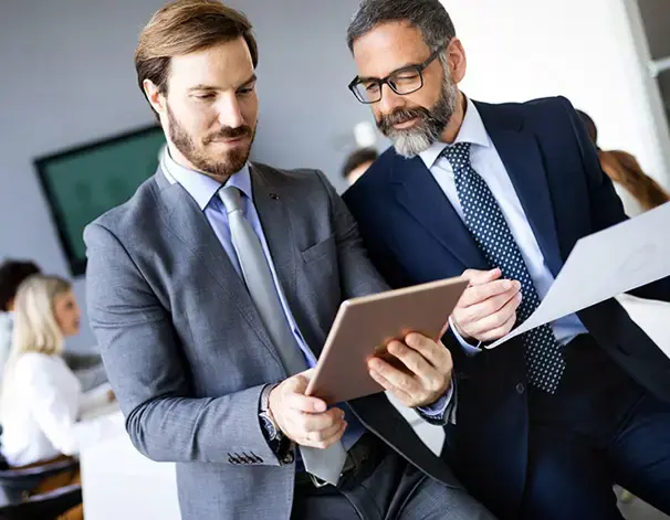 Two government professionals reviewing documents together in an office setting