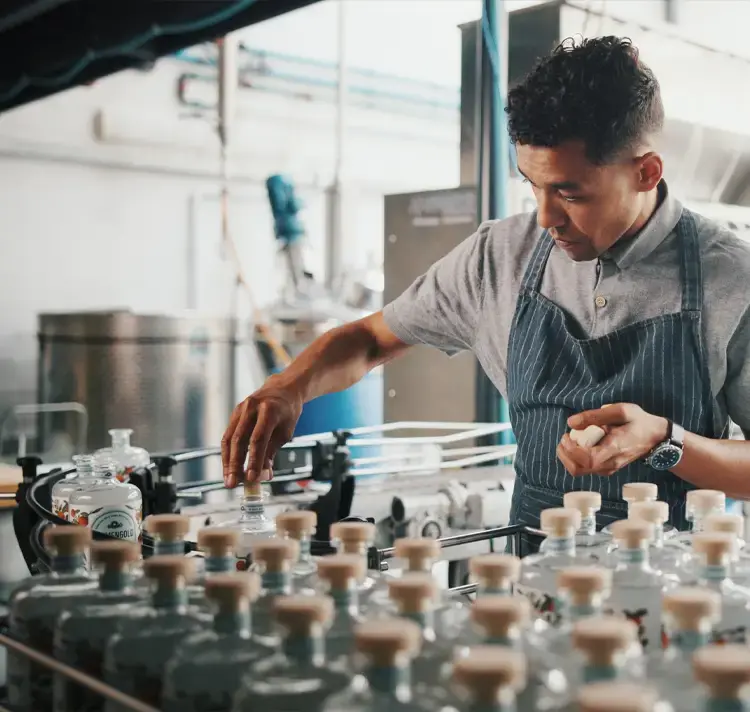 Person at a distillery doing quality control using Brutos Distillery Management Software